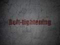 Finance concept: Belt-tightening on grunge wall background