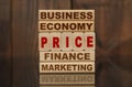 Wooden blocks with the text - Business, Economy, Finance, Marketing and PRICE