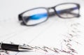 Finance, financial analysis, accounting accounts spreadsheet with pen glasses Royalty Free Stock Photo