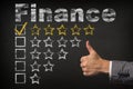 Finance five 5 star rating. thumbs up service golden rating stars on chalkboard Royalty Free Stock Photo
