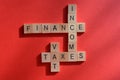 Finance, Income, VAT and Taxes, words in 3d wooden alphabet letters Royalty Free Stock Photo