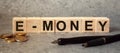 Finance, inscription on cubes, word E-MONEY on cubes of wooden texture