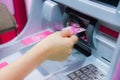 Finance, money, bank concept - female hand with cash and credit card at atm machine Royalty Free Stock Photo