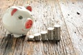 Finance stack coins and piggy bank on wood table Royalty Free Stock Photo