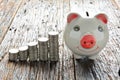 Finance stack coins and piggy bank on wood table Royalty Free Stock Photo