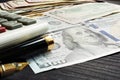 Finances or loan concept. Dollar banknotes and calculator on a desk.