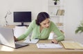 Financial accountant sitting at office desk with laptop computer and doing paperwork Royalty Free Stock Photo