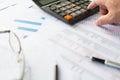 Financial accounting, Closeup, Man's finger pressing a calculator button To calculate financial transaction numbers, A pen, Royalty Free Stock Photo