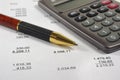 Financial accounting with pen and calculator Royalty Free Stock Photo