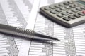 Financial accounting with pen and calculator Royalty Free Stock Photo