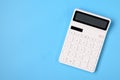 Financial activity, accounting, tax calculation or saving and investment, white calculator on solid blue background with copy Royalty Free Stock Photo