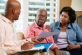 Financial Advisor Talking To Senior Couple At Home Royalty Free Stock Photo