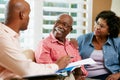 Financial Advisor Talking To Senior Couple At Home