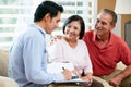 Financial Advisor Talking To Senior Couple At Home Royalty Free Stock Photo