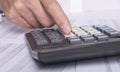 Financial analysis concept, male hands using a calculator over accounting documents, extra closeup Royalty Free Stock Photo