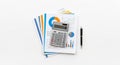 Financial analysis documents with colorful charts and graphs stacked with a calculator and pen on a white background for business Royalty Free Stock Photo