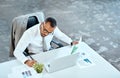 Financial analyst, focus and black businessman writing in his office space or reading data report and employee on desk Royalty Free Stock Photo