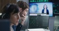 Financial analysts work on multi-monitor computer