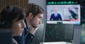 Financial analysts work on multi-monitor computer