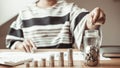 Financial businesswoman with coins put in a jar, Saving money for future growth and knowing how to manage your spending wisely