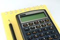Financial calculator with notebook and pencil