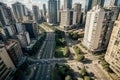 Financial center of a metropolis with large avenues, lots of trees, cars and people Royalty Free Stock Photo