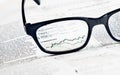 Financial chart and graph currencies see through glasses lens on financial newspaper Royalty Free Stock Photo