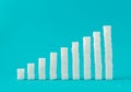 Financial chart made of sugar cubes with blue background. Sugar