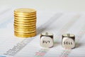 financial charts, coins and dice cubes with words Sell Buy. Selective focus