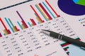 Financial charts and a pen on the desktop. Data analysis and revenue forecast. Accounting and Finance. Rank research and