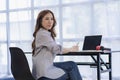 Financial concept of ambitious asian business woman working from home looking at laptop screen and smiling. Woman checking mail