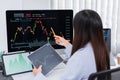 Financial concept a businesswoman studying the stock chart to decide to invest in which stock fund