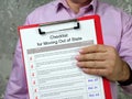 Financial concept about Checklist for Moving Out of State with sign on the piece of paper