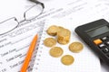 Financial concept. Close-up coins, pen, calculator and glasses at financial report Royalty Free Stock Photo