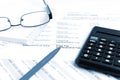 Financial concept. Close-up pen, calculator and glasses at financial report. Royalty Free Stock Photo