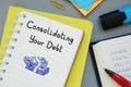 Financial concept about Consolidating Your Debt with sign on the piece of paper