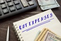 Financial concept about CUT EXPENSES with phrase on the sheet Royalty Free Stock Photo