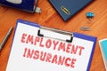 Financial concept about EMPLOYMENT INSURANCE with sign on the sheet