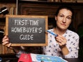 Financial concept about FIRST-TIME HOMEBUYER`S GUIDE with phrase on the board