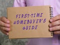 Financial concept about FIRST-TIME HOMEBUYER`S GUIDE with phrase on the piece of paper