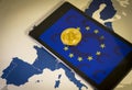 Financial concept with golden Bitcoin over smartphone, with EU flag, symbol and map