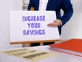 Financial concept about INCREASE YOUR SAVINGS with sign on the sheet