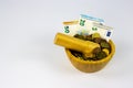 Financial Concept of Inflation - Euro Bills crushed to coins in a mortar grinded by a pestle with copy space Royalty Free Stock Photo