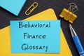 Financial concept meaning Behavioral Finance Glossary with inscription on the piece of paper
