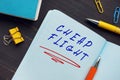 Financial concept meaning CHEAP FLIGHT with sign on the sheet. Cheapflights is a travel fare metasearch engine
