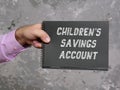 Financial concept meaning CHILDREN`S SAVINGS ACCOUNT with sign on the piece of paper Royalty Free Stock Photo