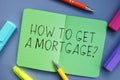 Financial concept meaning HOW TO GET A Mortgage? with inscription on the piece of paper Royalty Free Stock Photo