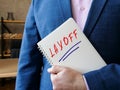 Financial concept meaning LAYOFF with phrase on the sheet Royalty Free Stock Photo