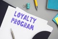 Financial concept meaning LOYALTY PROGRAM with phrase on the piece of paper Royalty Free Stock Photo