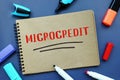 Financial concept meaning MICROCREDIT with phrase on the sheet